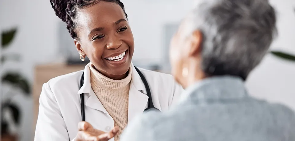 Image of woman doctor smiling at a patient