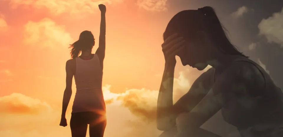 2 versions of a woman: One stands with arms raised in front of a vibrant sunset. The other is semi transparent of her silhouette, sitting down, head in hand.
