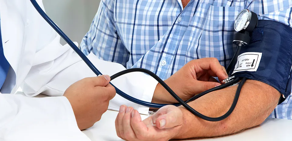 doctor taking patient's blood pressure