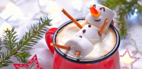 Red mug with hot chocolate and a melted marshmallow snowman