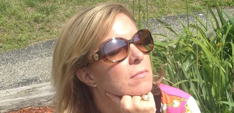 blonde woman sitting in the sun