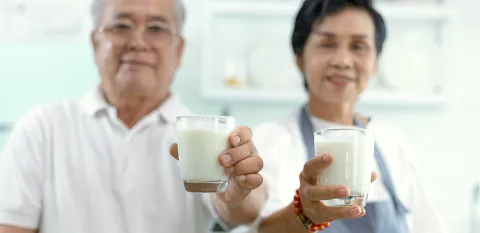 asian elderly couple drinking milk
