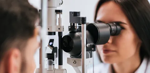 female doctor examining patients eyes