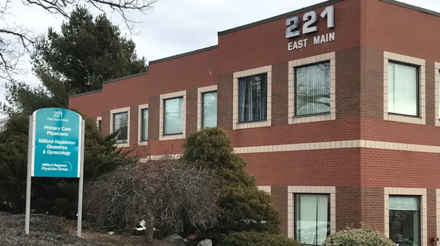 A brick building with a sign that reads "221 East Main."