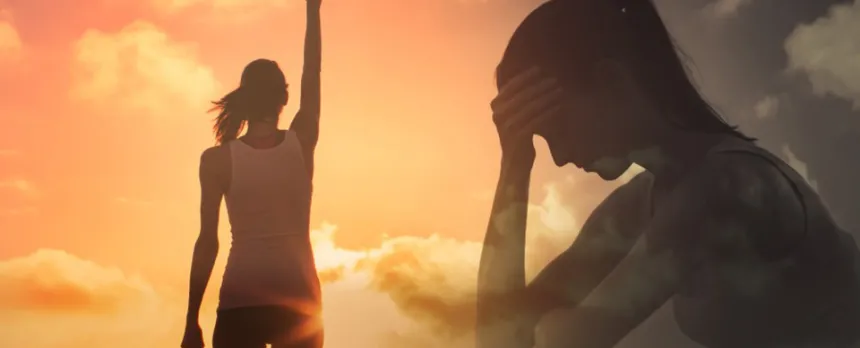 2 versions of a woman: One stands with arms raised in front of a vibrant sunset. The other is semi transparent of her silhouette, sitting down, head in hand.